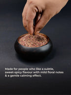 Hand dipping in a bowl of smoothmix herbal smoking blend 