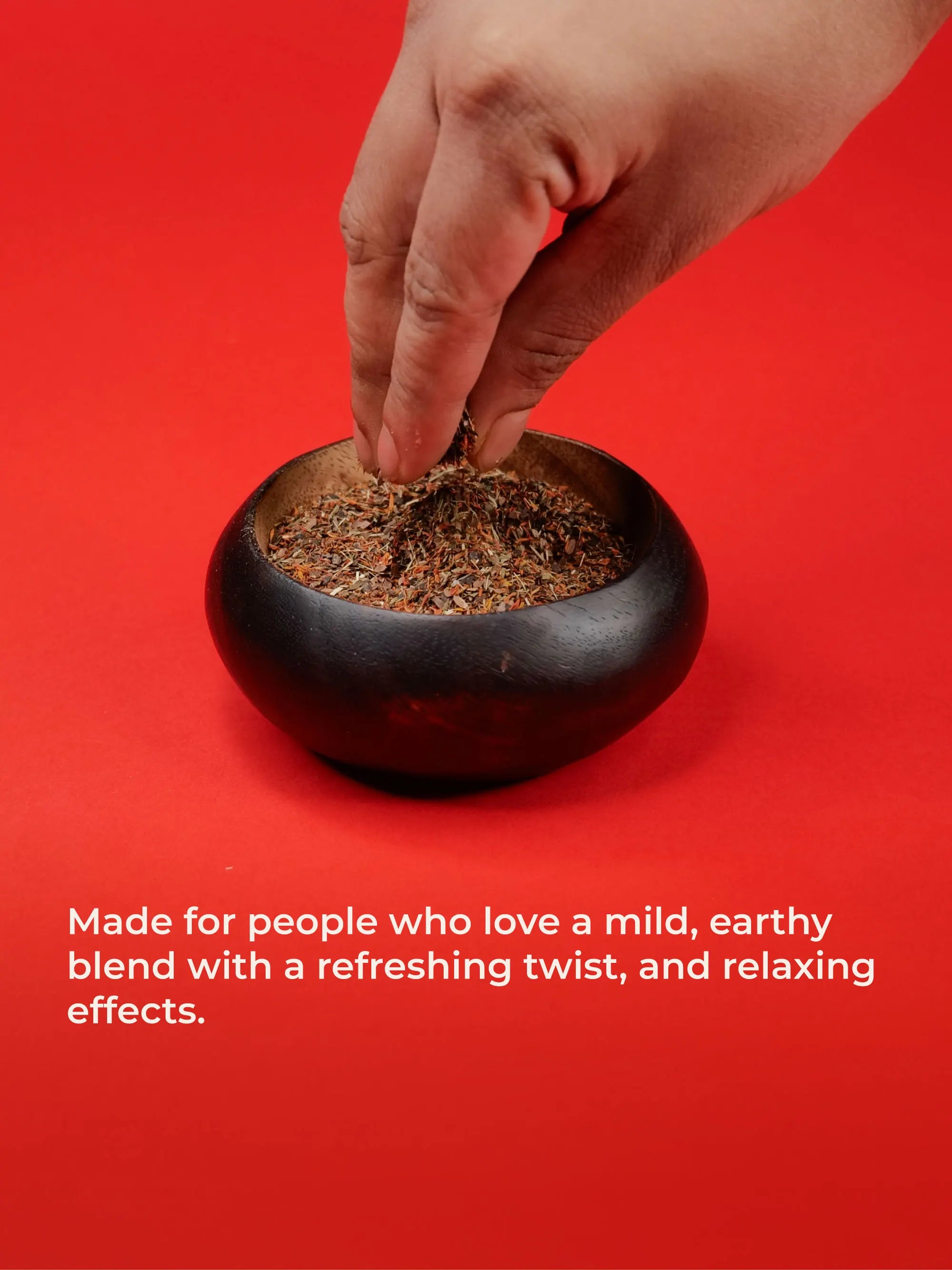 Hand reaching into a small black container of smoothmix herbal blend dried herbs on a red background with text about product effects.