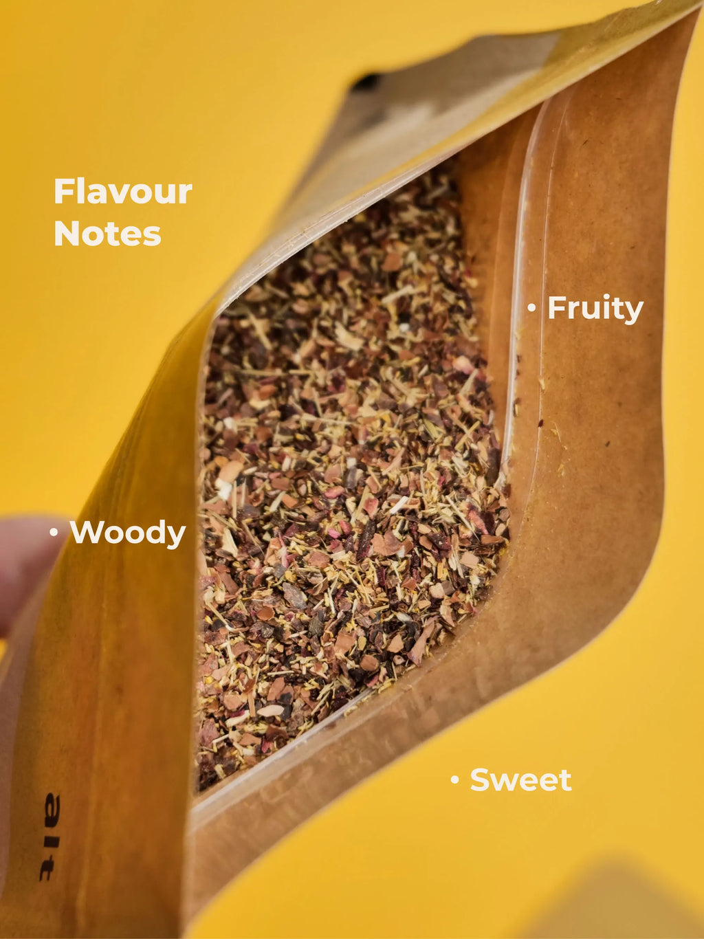 Open brown paper bag of Smoothmix ALT tobacco-free herbal smoking blend with visible contents on a yellow background, labeled with flavor notes.