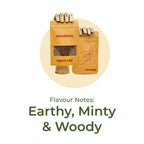 Two wooden mannequin hands hold smoothmix pouches labeled "agent red" and "smoothmix" over a beige circle. Below, bold text highlights the flavour notes: "Earthy, Minty & Woody.